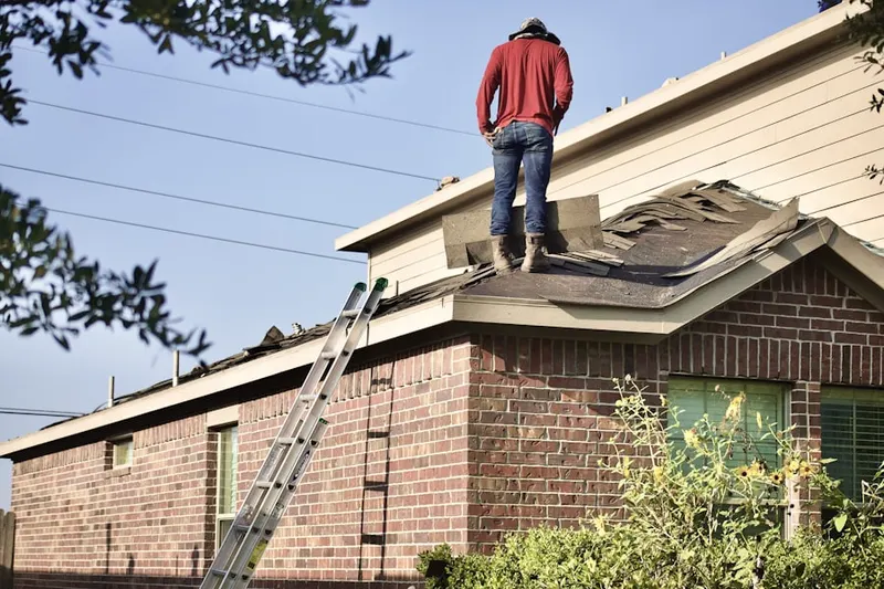 Professional roofer working on a residential roof in Anneewakee